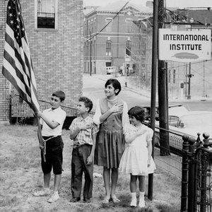 Children pledging allegiance outside the IINE-Lowell site. (1964)