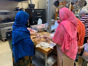 Afghan women cooking in church kitchen