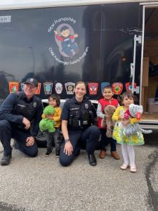 Police officers and Afghan children smiling