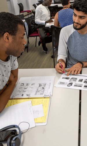 A tutor helps a student in our ESOL class